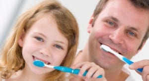Father and Daughter brushing their teeth